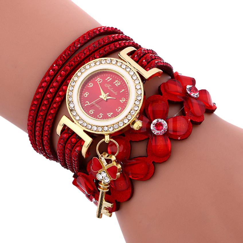 Key and Flowers Bracelet Watch Women This watch has all the best elements of the past, present and future. The modern, easy to read watch features a key hanging off the side and a attached flower design bracelet. You can tell time in an easy and efficient manner with this easy to read watch.