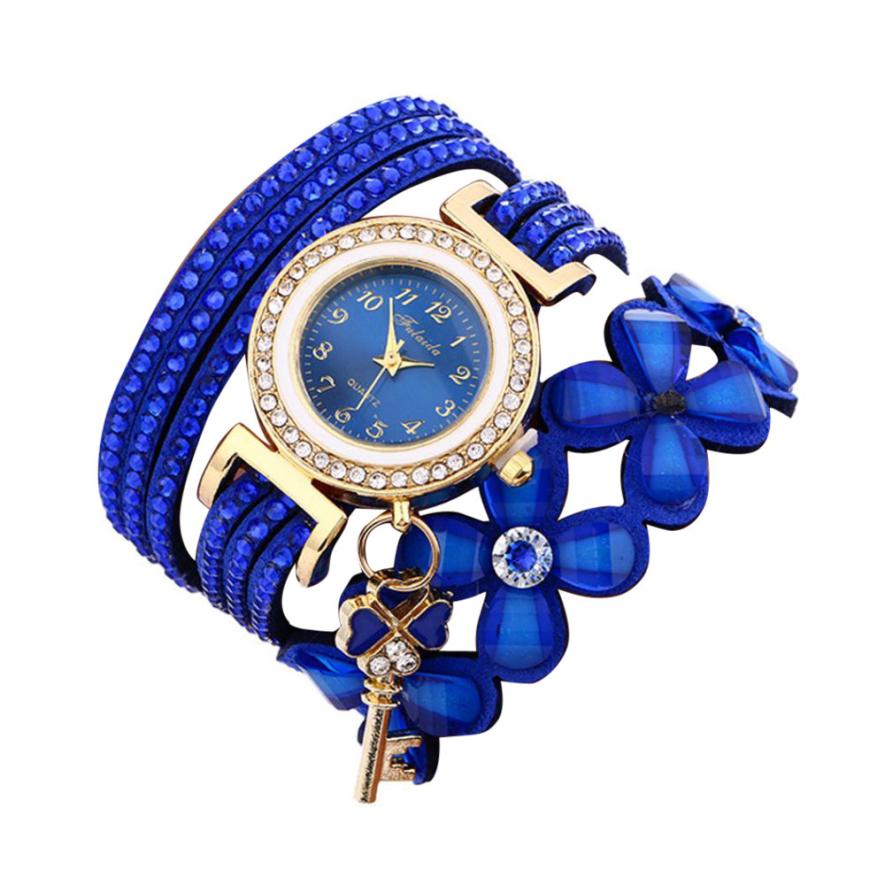Key and Flowers Bracelet Watch Women This watch has all the best elements of the past, present and future. The modern, easy to read watch features a key hanging off the side and a attached flower design bracelet. You can tell time in an easy and efficient manner with this easy to read watch.