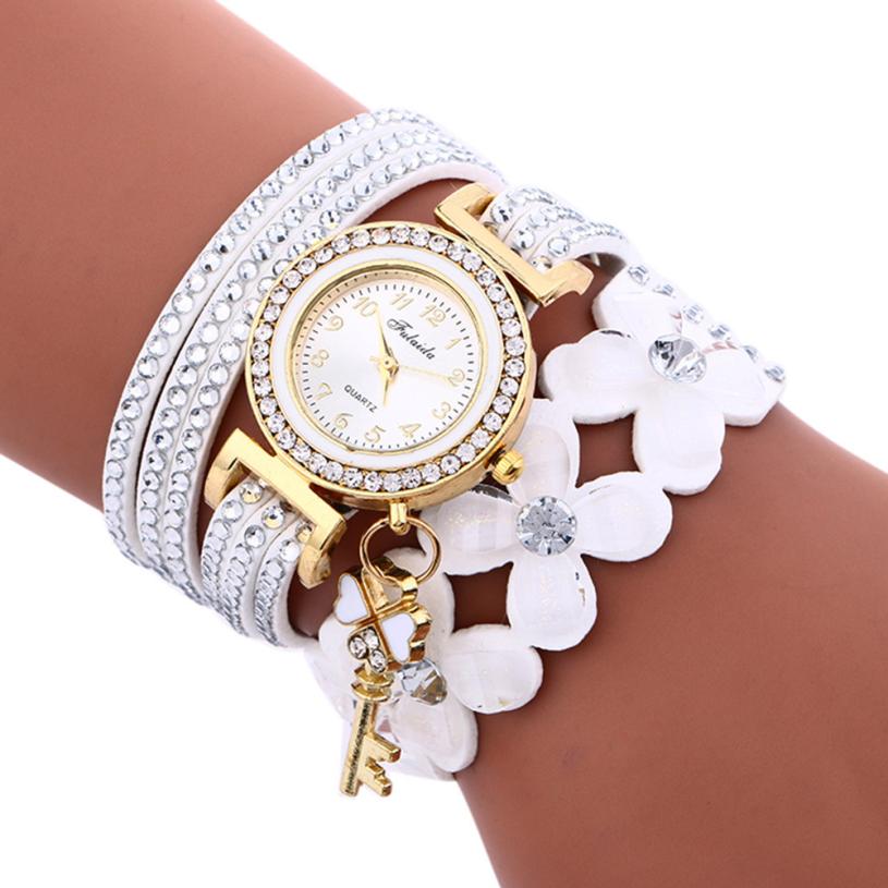 Key and Flowers Bracelet Watch Women This watch has all the best elements of the past, present and future. The modern, easy to read watch features a key hanging off the side and a attached flower design bracelet. You can tell time in an easy and efficient manner with this easy to read watch.