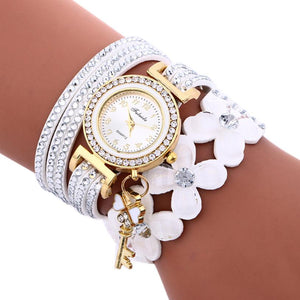 Key and Flowers Bracelet Watch Women This watch has all the best elements of the past, present and future. The modern, easy to read watch features a key hanging off the side and a attached flower design bracelet. You can tell time in an easy and efficient manner with this easy to read watch.